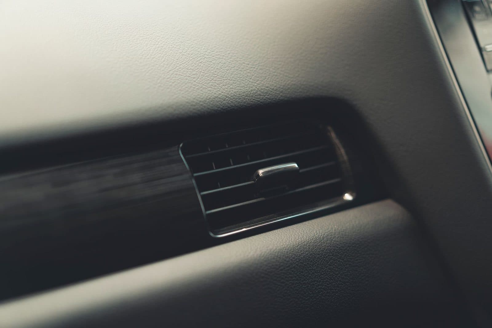 Close-up of a car air-con vent on the dashboard