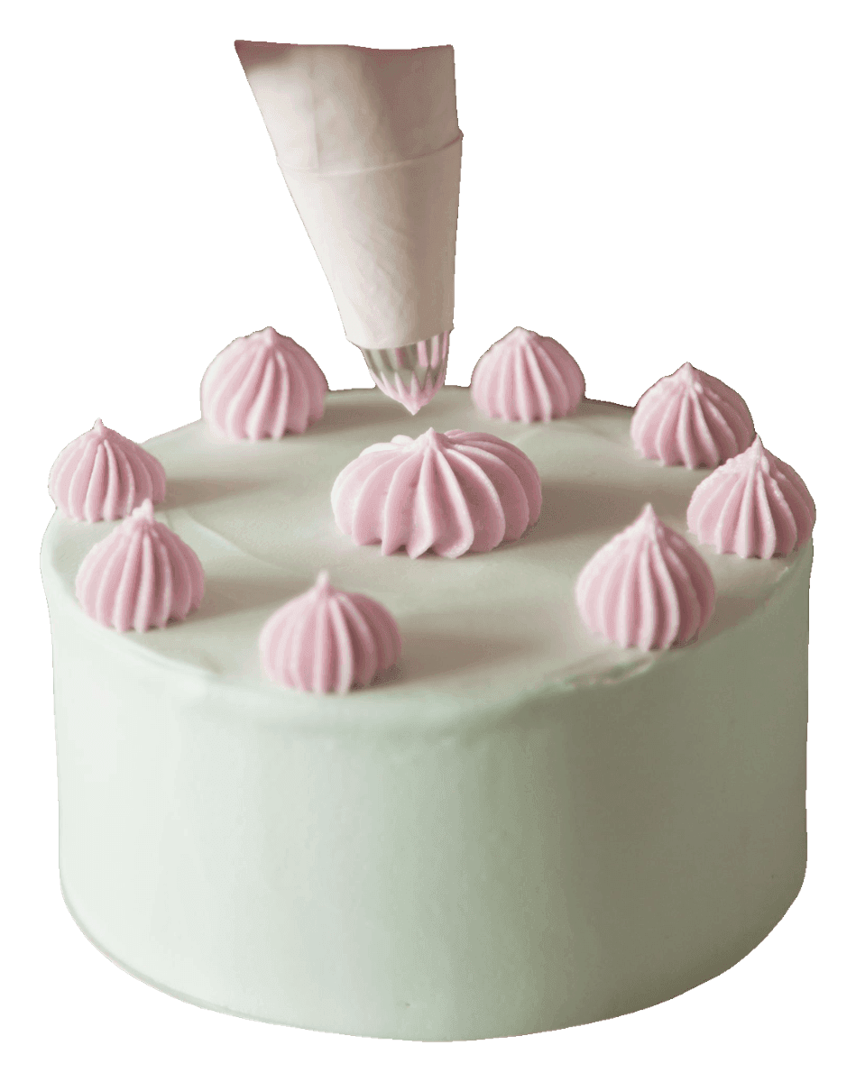 Mint green cake with pink buttercream kisses and a piping bag adding one more