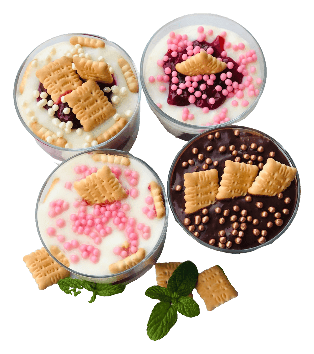 Four cake and cream dessert cups topped with sprinkles and little biscuits