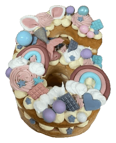 Unicorn and rainbow number 8 cream tart cake with pastel balls and sweets for a kids' birthday, made in Townsville