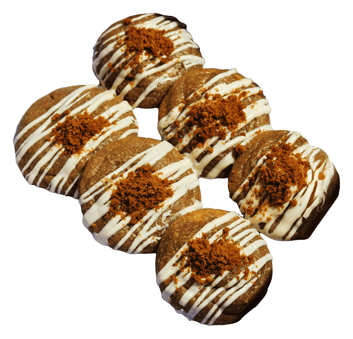 Six cookies with white icing drizzle and biscuit crumb on top