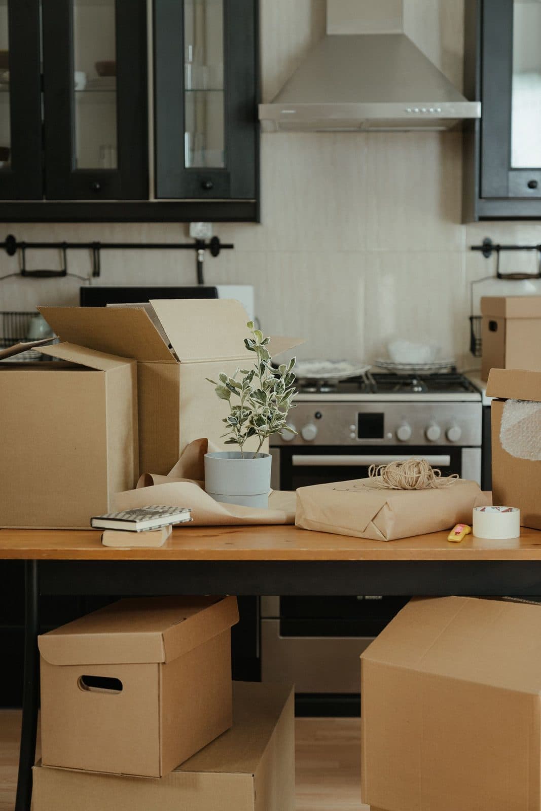 Kitchen bench surrounded by moving boxes on moving-in day
