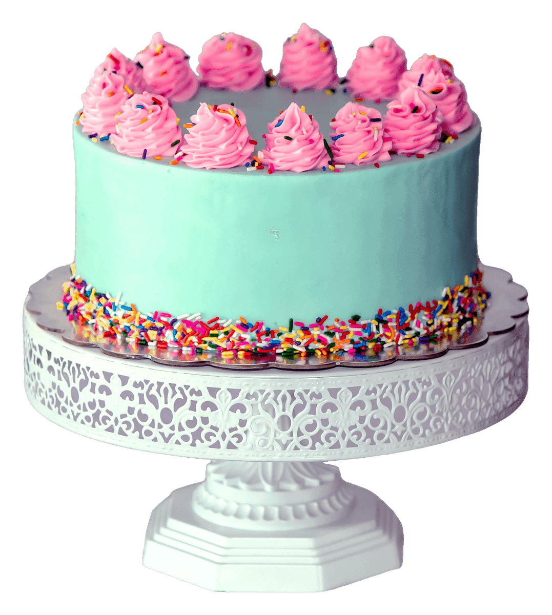Mint green cake with pink piped swirls and a rainbow sprinkle border on a white stand