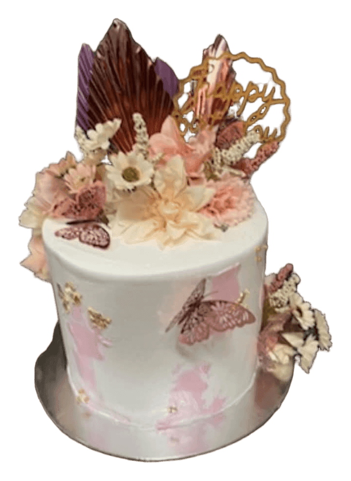 White birthday cake with dried flowers, butterflies and a gold topper, Townsville